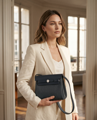 Arvelle Paris luxury handbag — editorial styling, held by model in Parisian setting